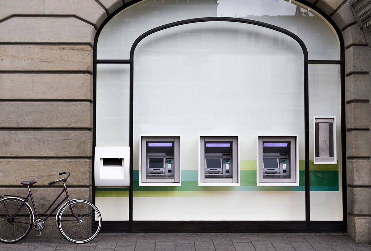 A shop window with 3 cash dispensers